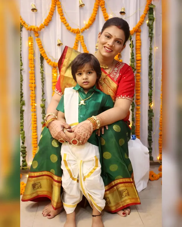 A mother and son dressed in beautiful traditional South Indian attire for a ceremony. We are experienced in photographing various cultural events and their specific dress codes.