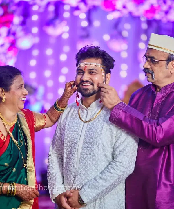 A beautiful, candid moment between the groom and his parents. These lighthearted family interactions are full of love and make for unforgettable photos.