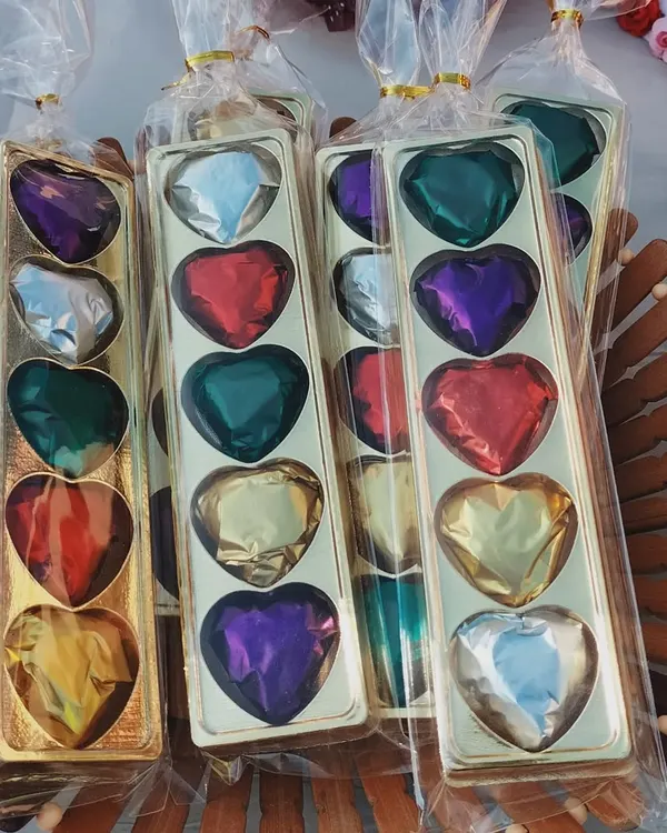 These jewel-heart chocolates are one of my favorite things to make. Each one is handmade and wrapped in colorful foil, making them a beautiful and delicious gift for someone special. They are perfect for custom chocolate gift boxes.