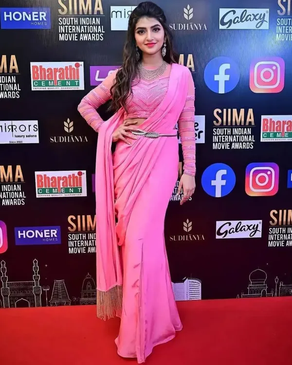 Actress Sreeleela looking radiant on the SIIMA Awards red carpet in our modern pink pre-draped saree. You can rent this exact celebrity-worn outfit for your special event.