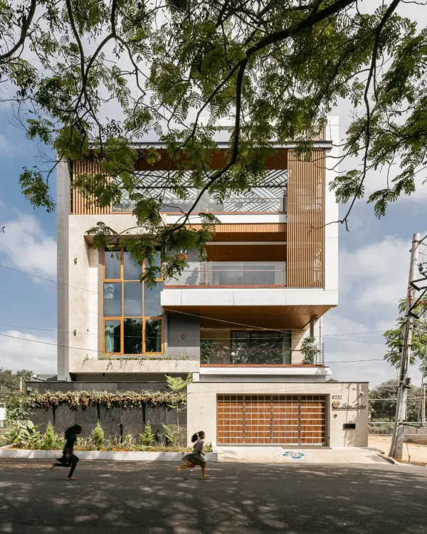 This is our recently completed residence on Hennur Road. The facade balances Italian marble, contrasting textures, and wooden soffits to create an elegant, contemporary home with a strong vertical presence and a welcoming warmth.