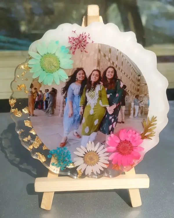 This floral photo frame is perfect for celebrating friendship. I surrounded a picture of three friends with a variety of colorful pressed flowers, creating a vibrant and cheerful keepsake that sits on a small wooden easel.