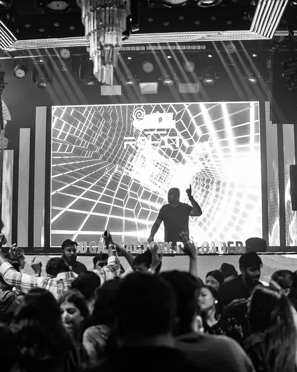 A black and white shot of me on the decks at Sugar Factory, with the crowd's hands in the air. This captures the pure energy of our Wednesday nights.