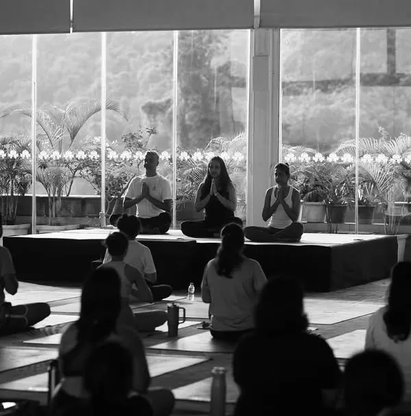 A black and white shot of our community in meditation during an outdoor session. This image captures the shared silence and focus that connects us on a deeper level.