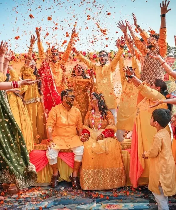 The quintessential Haldi moment. We love capturing the energy of friends and family as they shower the couple with love and flower petals, creating a memory that lasts a lifetime.