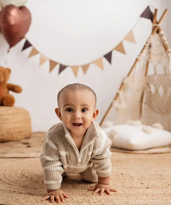 A classic crawling pose in our boho setup, perfect for capturing this adorable milestone.
