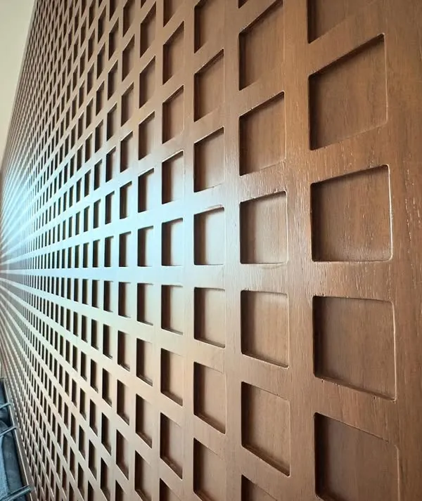 A detailed look at the custom CNC-cut wood paneling we created for a headboard. The repeating geometric pattern adds depth and a highly tactile quality to the bedroom wall.