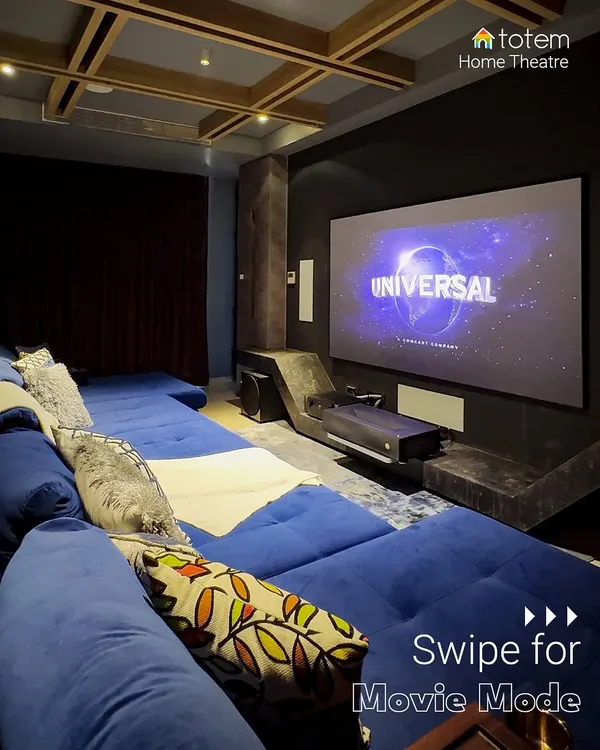 A view of a completed home theater featuring a large projection screen and comfortable, multi-level seating. This setup is perfect for hosting friends or enjoying a family movie marathon, providing a better-than-the-multiplex experience.
