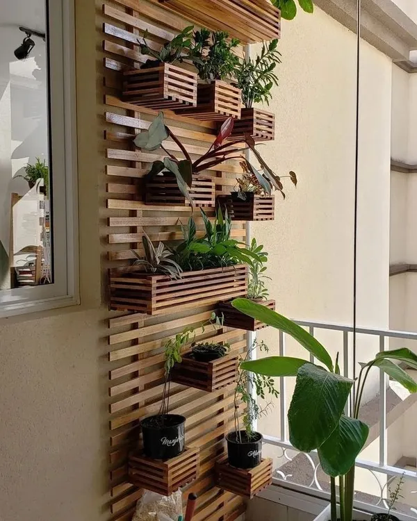 This vertical garden is made from a wooden slat structure with integrated planter boxes. It's a modular and stylish way to display a variety of plants at different heights, creating a living wall of art.
