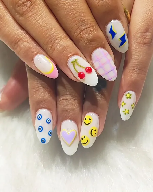 Why choose one design when you can have them all? This playful set on almond-shaped nails features a different hand-painted design on each finger, including smiley faces, cherries, evil eyes, and lightning bolts.