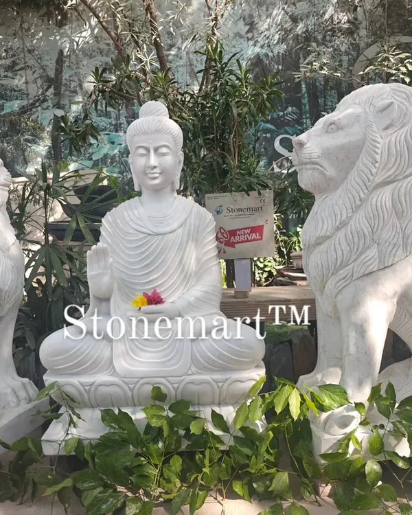 This impressive setup features a 4-foot white marble Buddha statue guarded by two 4-foot hand-carved marble lions. Each lion weighs 500 kg, making this a truly grand statement for a hotel, resort, or farmhouse entrance.