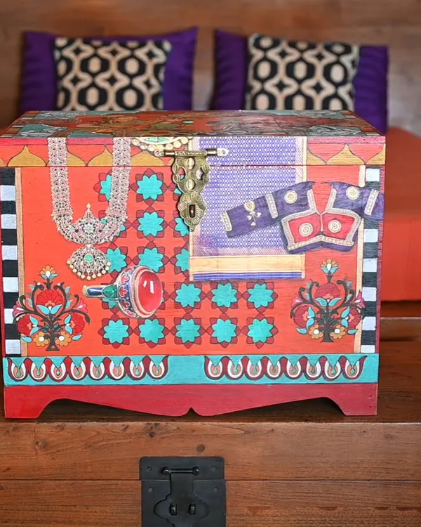 This handmade memory box, made from salvaged teak, is a tribute to the material culture of another era. The front panel features a collage of traditional Indian jewelry and textiles, perfect for storing your own treasures.