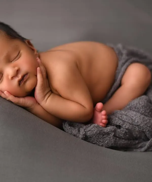 A classic and timeless newborn portrait. This 'head on hands' pose is a favourite among parents, showcasing the baby's peaceful sleep and tiny, perfect features. I use specific posing techniques to ensure your baby is always safe and comfortable.