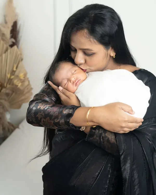 A mother's kiss is the purest form of love. This tender moment between a mom and her newborn is something she will cherish for a lifetime.