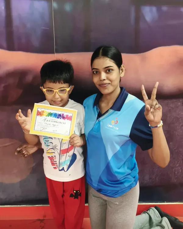 Another happy student proudly showing his certificate. We make sure every child's effort is recognized to build their self-esteem.