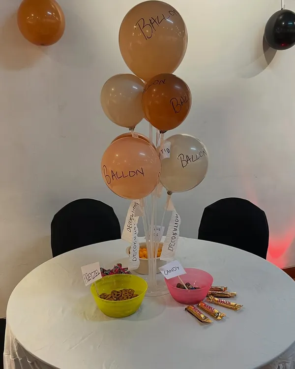 The details make the theme. For 'The Office' party, we created a centerpiece with poorly labeled balloons and bowls of snacks, a nod to the show's hilarious and understated party planning committee.