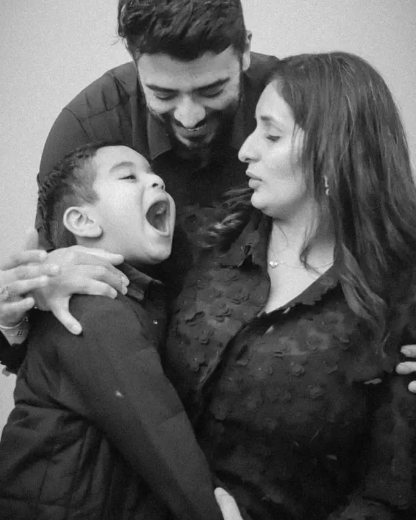 This photo is all about emotion. By removing color, we focus on the son's joyful expression and the parents' loving reaction.