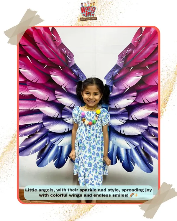 Every child is an angel at our studio. This student's bright smile perfectly complements our colorful wings mural, a favorite photo spot for everyone.