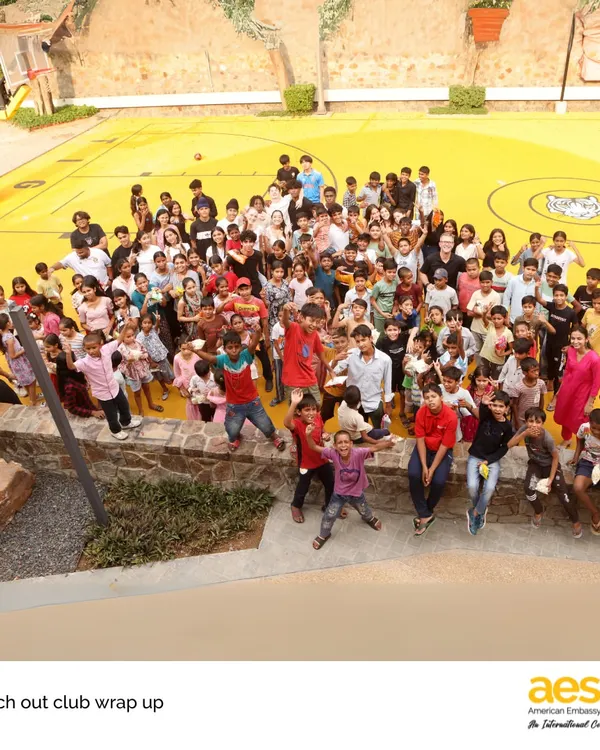 This is what our community looks like. A huge, vibrant group of students from our 'Reach Out!' service club coming together for a day of fun and connection. This image captures the joy, diversity, and spirit of service that we nurture in every student.