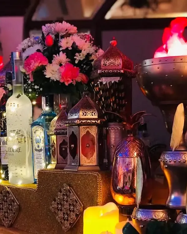 A glimpse into the luxurious ambiance of my Sufi-themed bar. The setup glows with warmth from Moroccan lanterns and dramatic flame bowls, creating an exotic and royal setting for your reception.