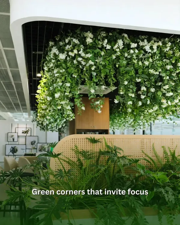 I believe in creating more than just decorated spaces. This is a green corner designed to invite focus, using a mix of hanging foliage and dense planters to build a serene, productive atmosphere within a busy office.