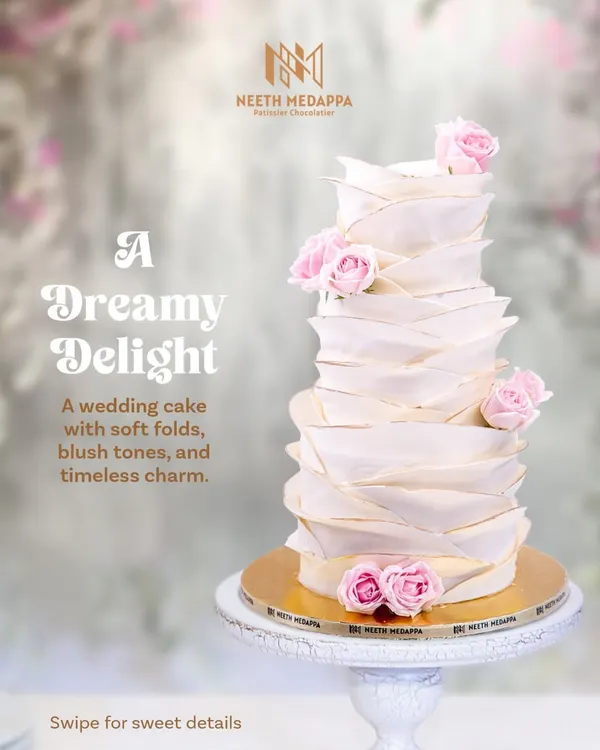 A dreamy delight for a timeless love story. This wedding cake features soft, hand-crafted folds, blush tones, and delicate pink roses, creating a sense of gentle movement and romance.