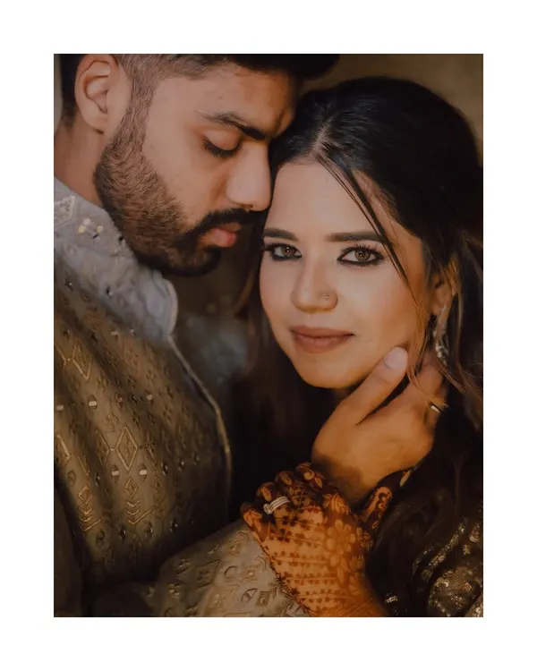 A beautiful and intimate close-up of the couple after their ring ceremony. The groom's hand gently holding her face, and her direct gaze at the camera, creates a powerful and romantic portrait.