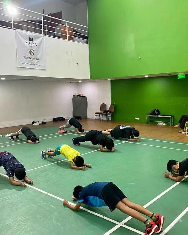 The plank is a fundamental exercise for building a strong core, which is essential for stability and power in every shot. Our players hold the position, building endurance together.