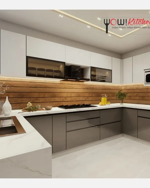 This U-shaped kitchen is the epitome of modern design. It combines matte grey lower cabinets with white upper cabinets and a warm wood-paneled backsplash, all illuminated by subtle under-cabinet lighting.