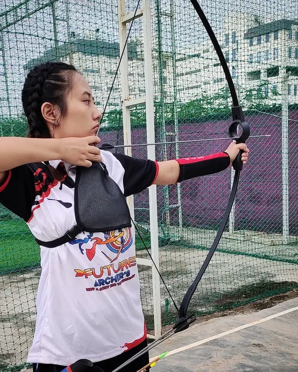This is perfect archery form in action. An archer from our academy demonstrates a full draw, with solid posture and intense focus, showcasing the high level of technical skill we cultivate.