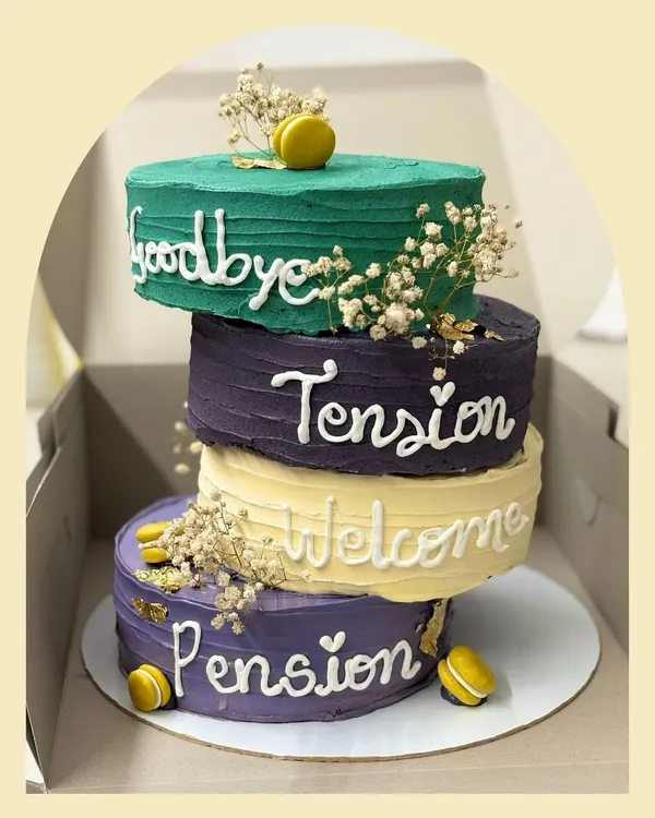 A unique four-tier topsy-turvy cake for a retirement party that reads "Goodbye Tension, Welcome Pension". This 2kg cake was a fun and memorable way to celebrate a new chapter.