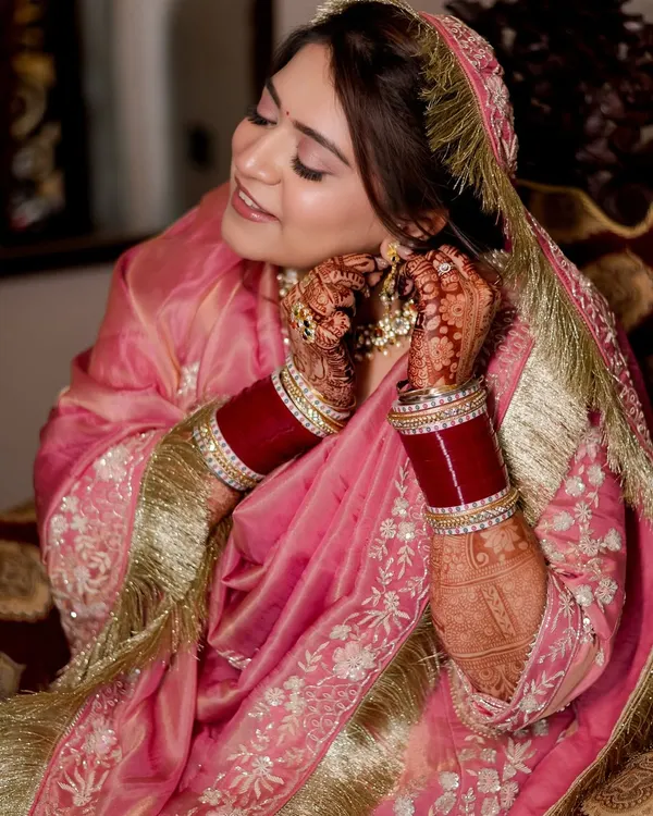 A soft and subtle Anand Karaj look for my beautiful Sikh bride, Shivangi. For this daytime ceremony, I focused on creating a flawless, glowing base with soft pink tones on the eyes and lips to complement her stunning pink suit.