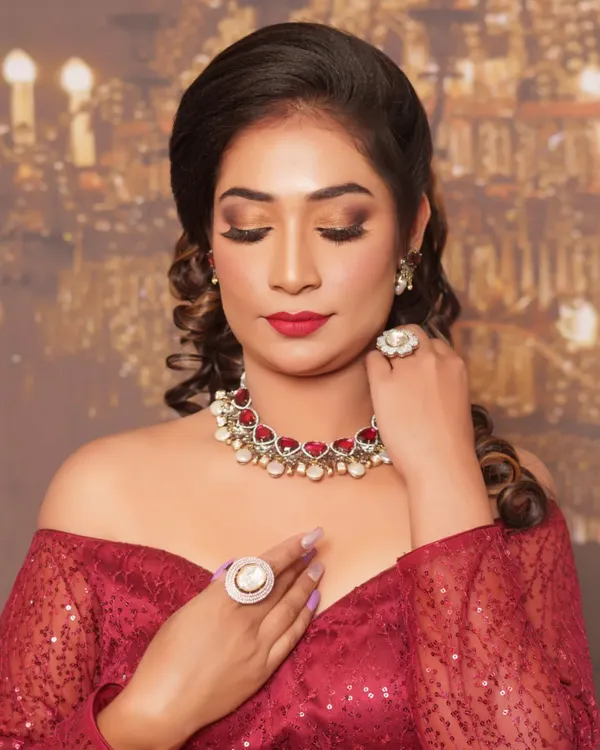 A close-up of this glamorous reception look. We went for a warm, blended smokey eye, flawless airbrushed-finish skin, and a classic red lip. The focus is on creating a sophisticated and polished look that lasts all night.