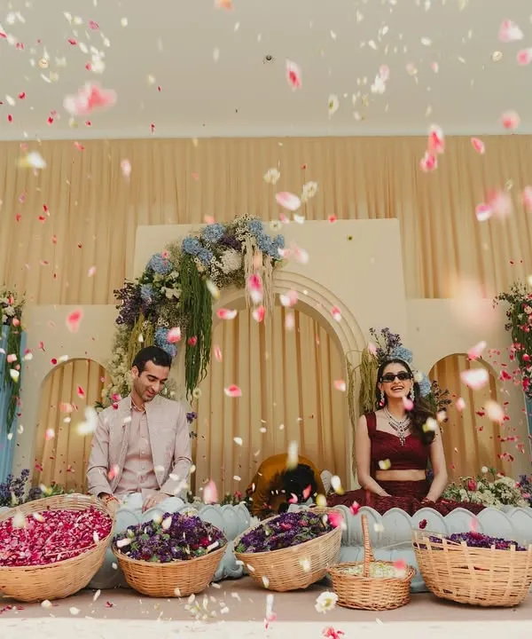 This is the moment it all comes together. A 'Petals of Joy' Haldi ceremony, where the couple is showered with blessings and flowers by their loved ones against a backdrop of soft pastels and cascading florals.
