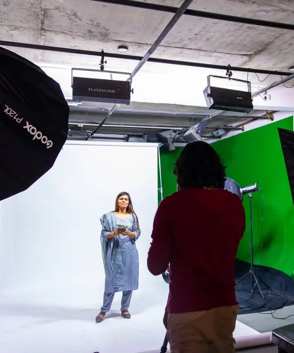On set for a commercial ad shoot, managing a green and white screen setup. This shows the scale of production I handle, complete with professional lighting and a dedicated space for client monitoring.