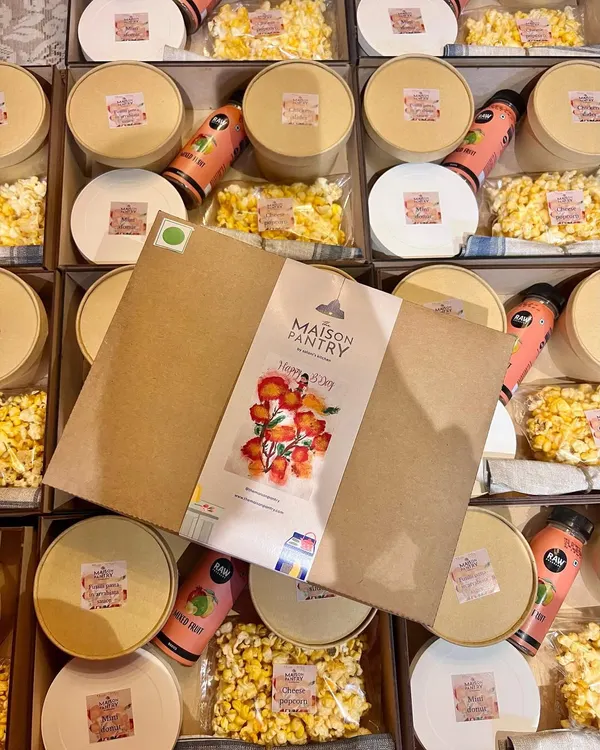 A top-down view of my kids' party boxes ready to go. The custom-branded packaging and neatly arranged items show the care and attention to detail that goes into making each child's meal a special treat.