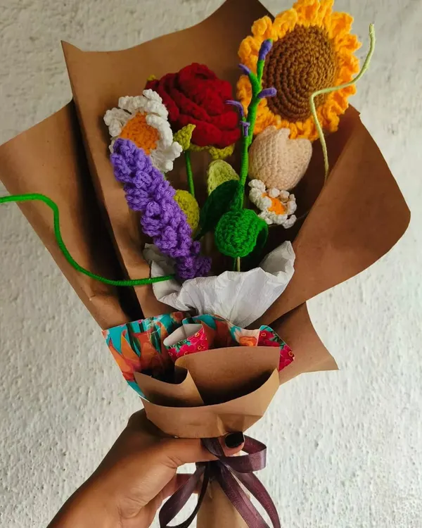 I love making these mixed bouquets because they are so full of life and color. This one combines a sunflower, rose, daisy, and lavender, all wrapped in rustic kraft paper.