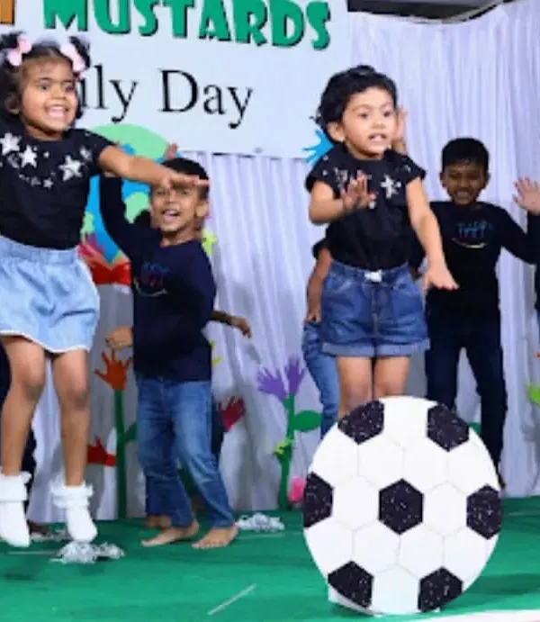 The pure energy and excitement of our Family Day performance. The children worked together to put on a show for their parents, and their joyful jumping says it all.