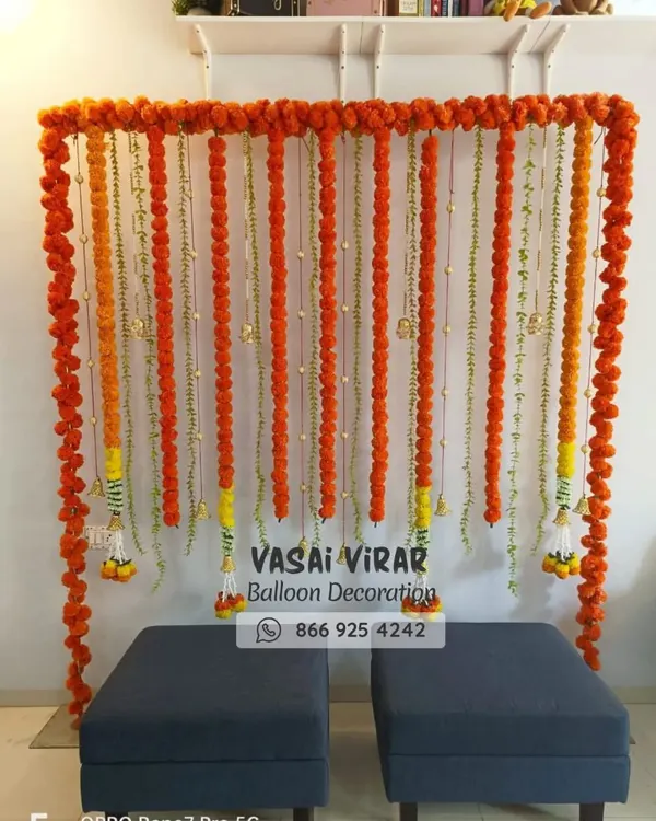 Here is a classic and vibrant backdrop we designed, perfect for a Haldi ceremony or a naming ceremony. We used strings of fresh orange marigold flowers to create a simple yet beautiful photo corner, bringing a touch of tradition to the event.