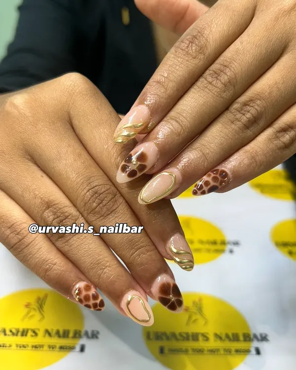 A sophisticated set featuring earthy tones. I hand-painted abstract floral and giraffe-like patterns in a rich cocoa brown, complemented by elegant gold line work on a nude base.