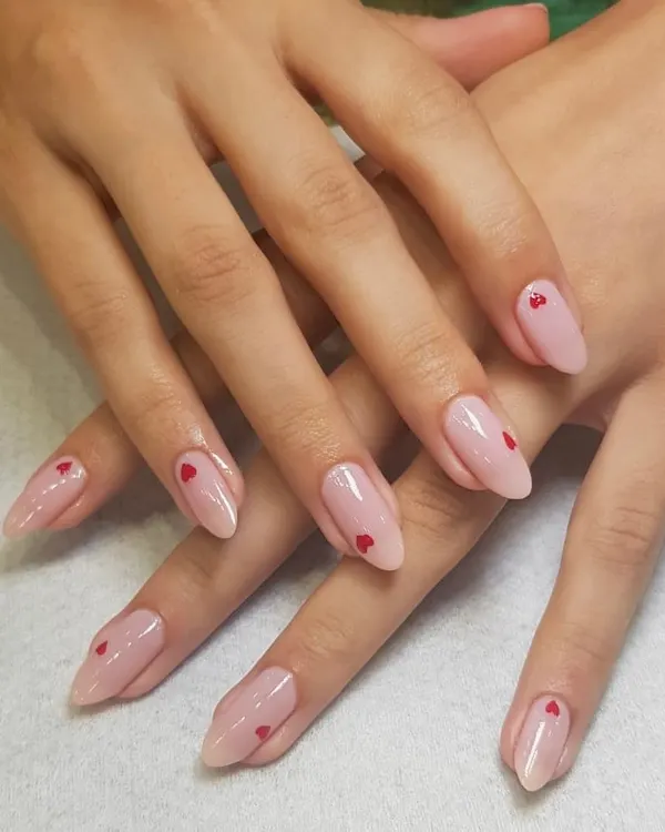 The finished product. Here are the delicate heart nails, perfectly executed on a sheer pink base with an elegant almond shape. I love making your nail dreams come true.