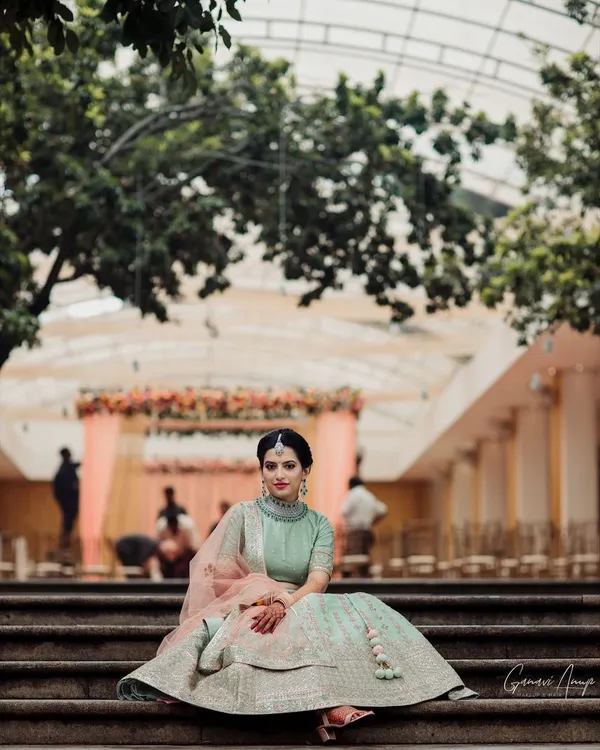 Roshni looking absolutely regal for her engagement. I created a soft, natural makeup look to complement her pastel green lehenga and diamond jewelry, perfect for this elegant outdoor setting.