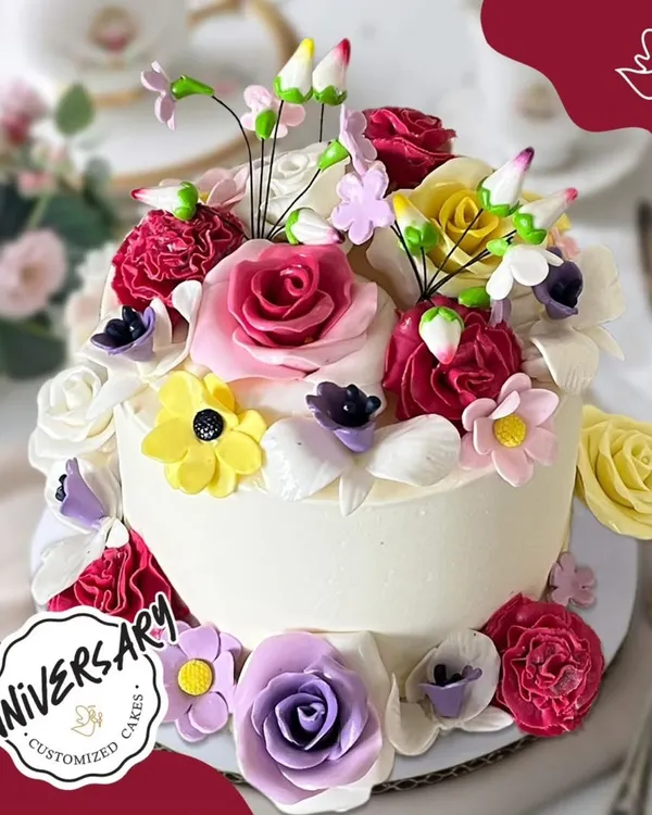 A vibrant garden of love for Tushar and Jiya's anniversary in Sushant Lok. This stunning cake is overflowing with a variety of colorful, handcrafted sugar flowers, making it a true feast for the eyes.