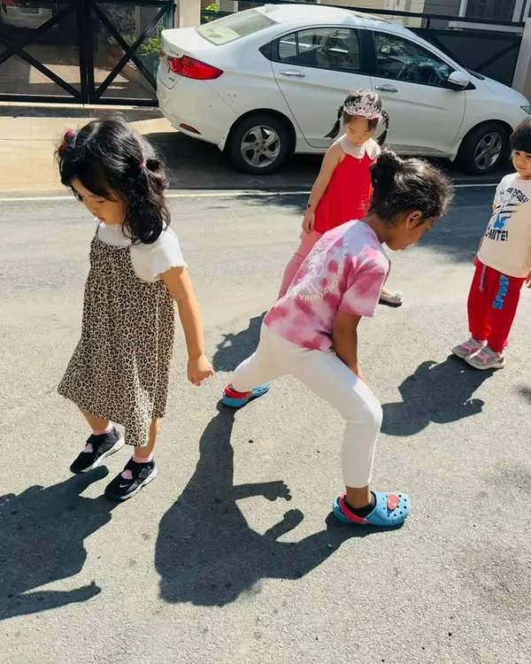 We took learning outside to explore how shadows are formed. Here, children observe their own shadows on the pavement, making a direct connection between their bodies, the sun, and the light.