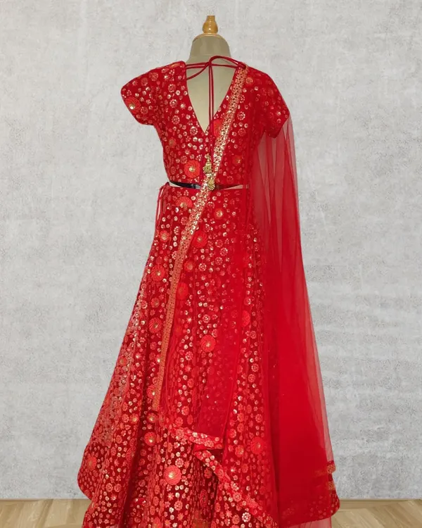 This rich red lehenga is a showstopper, designed for weddings and grand celebrations. The all-over embroidery and classic silhouette are handcrafted for a look of timeless elegance.