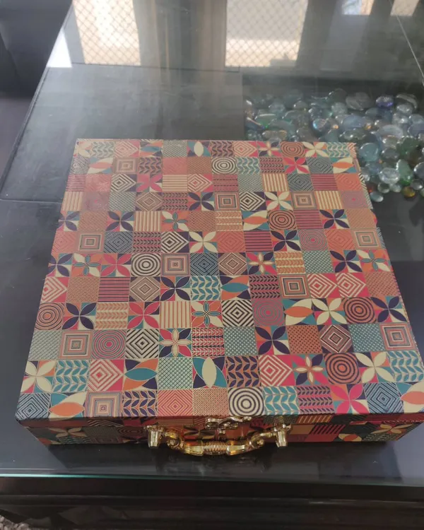 This is the exterior of a large, custom wedding box I created for my brother's wedding. The vibrant, patterned suitcase-style box with a handle is a gift in itself.