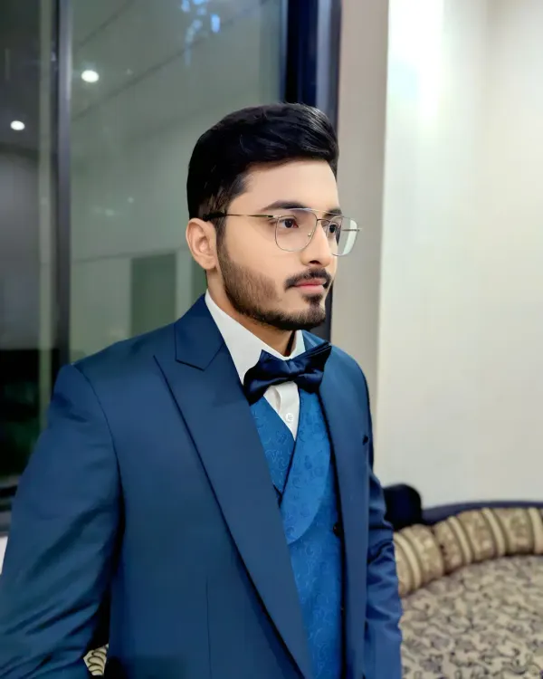 A sharp and modern look for a reception or engagement. This three-piece blue suit with a bow tie is a stylish choice for any evening event.