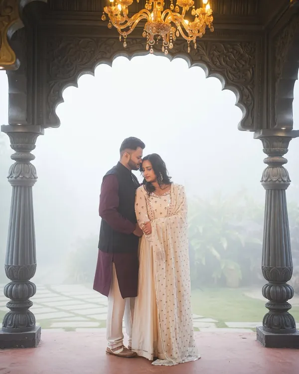 This is one of my favorite shots from our Indian palatial set. The grand archway, elegant chandelier, and the natural morning mist create a truly cinematic and romantic atmosphere for pre-wedding photography.