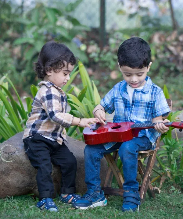 Two little brothers sharing a sweet melody. Capturing the connection between siblings, their curiosity and their shared moments of play, is one of the great joys of my work.
