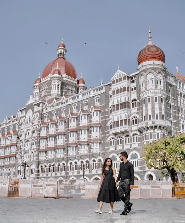 A wide shot that captures the grandeur of the Taj Mahal Palace Hotel. I position the couple walking in the foreground to create a photo that feels both epic and personal.